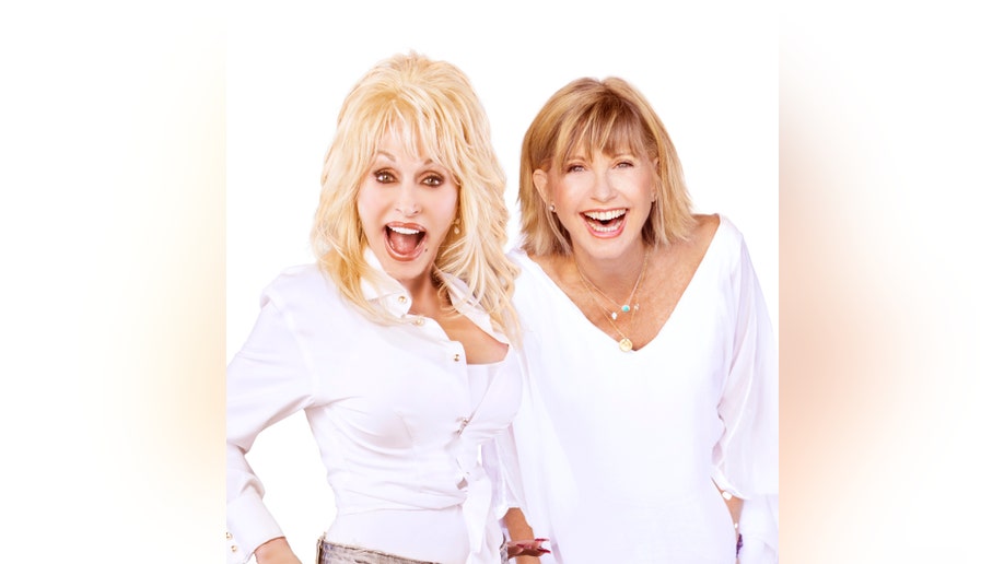 Dolly Parton and Olivia Newton-John smile for a photo together