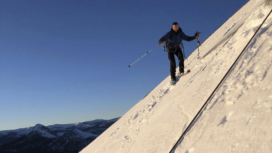 Jason Torlano smiles while skiing