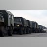 Russian military trucks and buses are seen on the side of a road in Russia's southern Rostov region, which borders the self-proclaimed Donetsk People's Republic, on February 23, 2022. (Photo by STRINGER / AFP) (Photo by STRINGER/AFP via Getty Images)