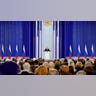 Russian President Vladimir Putin gives a speech to a crowd.