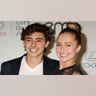 Hayden Panettiere beams on the red carpet wearing a black lace outfit next to younger brother Jansen in a white v-neck shirt and black suit