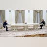 Two men sit across from each other.