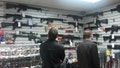 Customers view semi automatic guns on display at a gun shop in Los Angeles, California December 19, 2012.