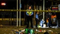 Police officers collect evidence at the scene of a shooting that occurred during the Krewe of Bacchus parade Feb. 19, 2023 in New Orleans.