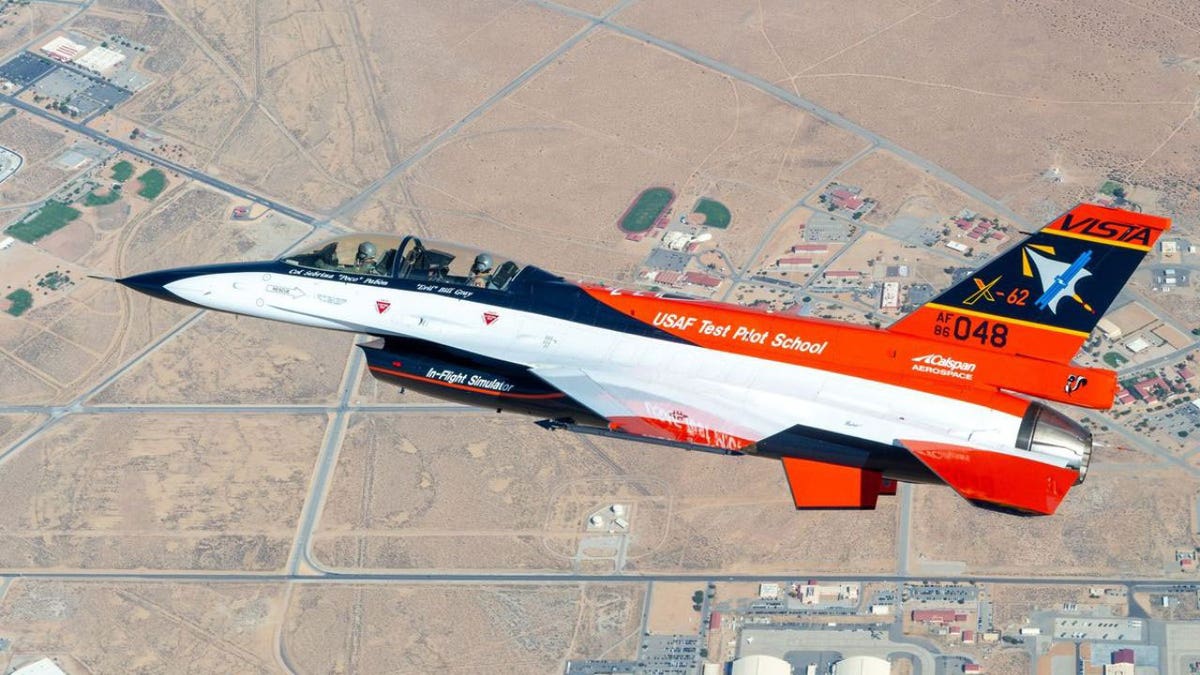 Jet flying over a desert landscape.
