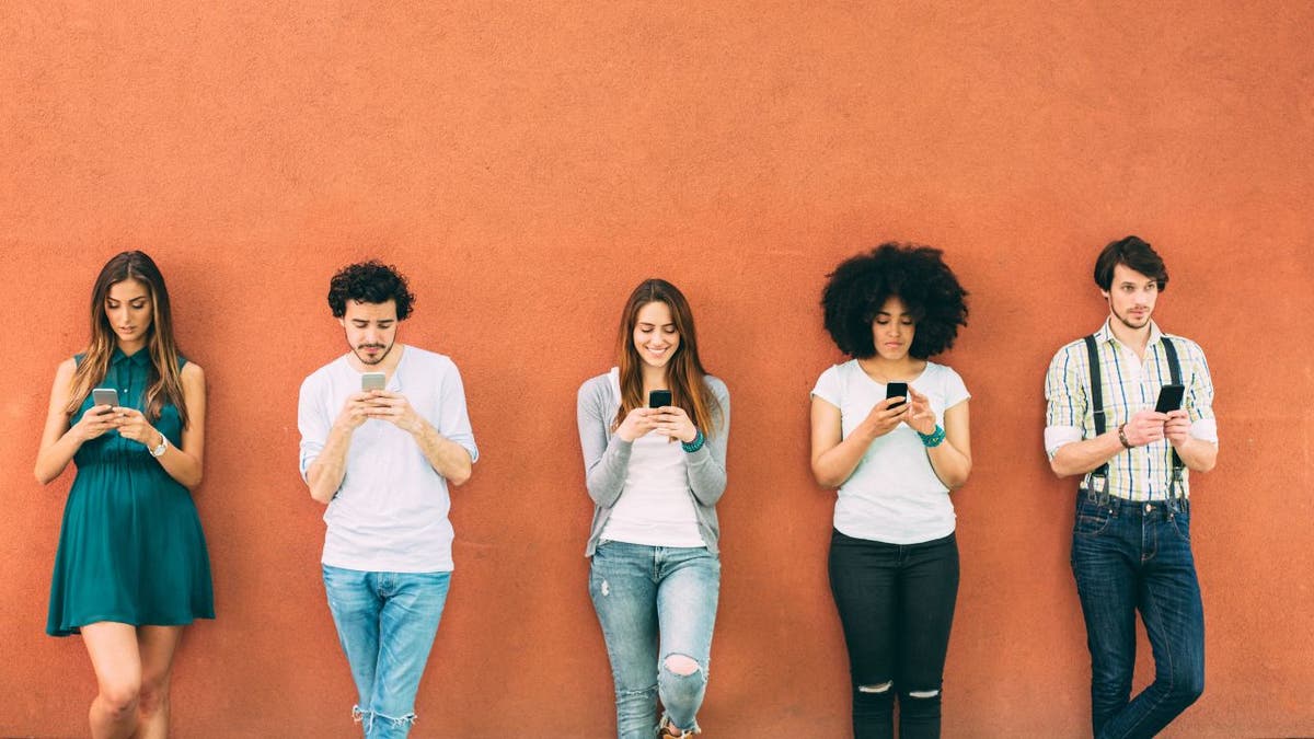 A group of young people texting separately.