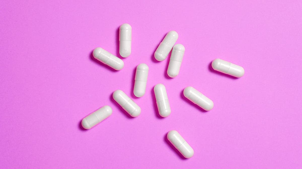 Prescription medication on a pink background