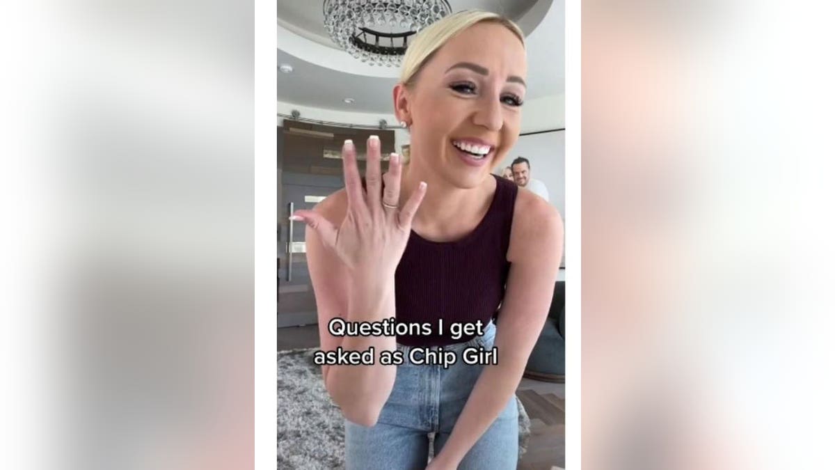 A woman holding up her hand where she claims to have gotten chipped.