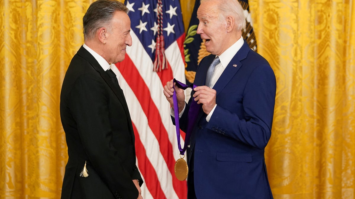 U.S. President Joe Biden presents singer Bruce Springsteen with a National Medal of Arts during a ceremony in the East Room at the White House in Washington, U.S., March 21, 2023. REUTERS/Kevin Lamarque
