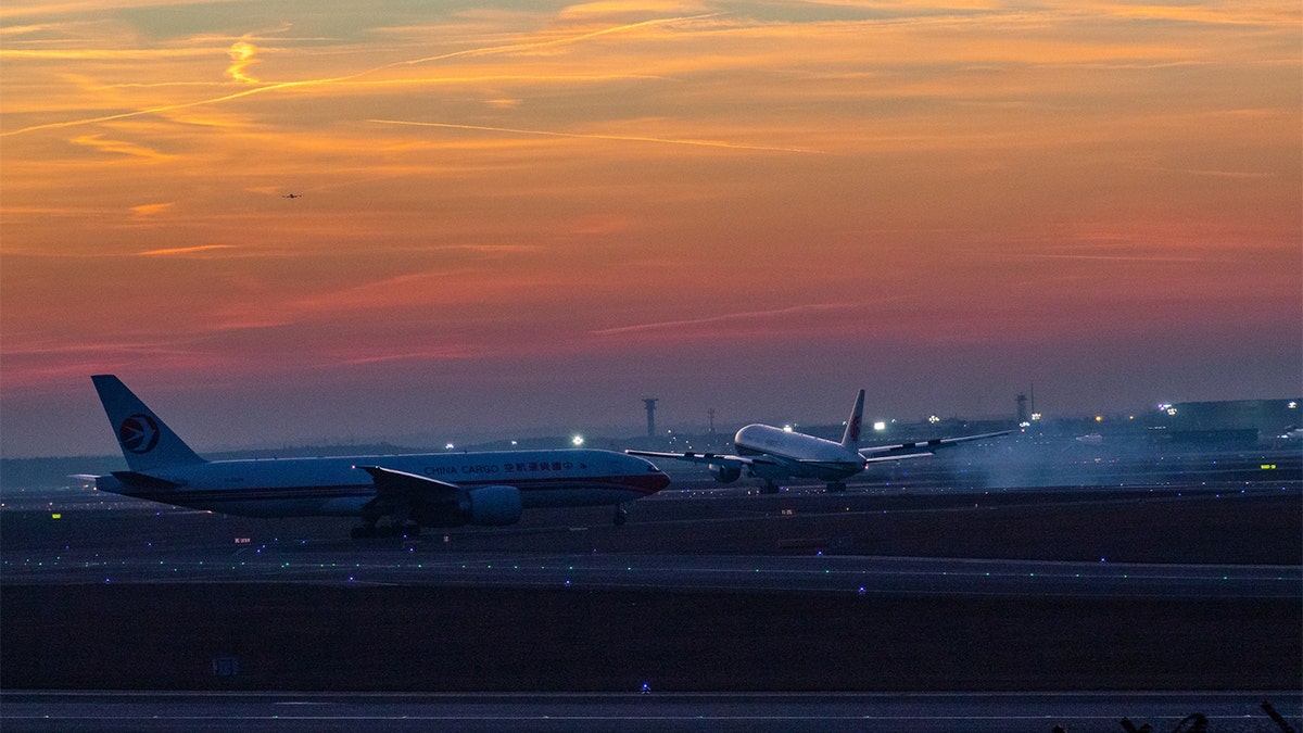Airplane on tarmac during sunset