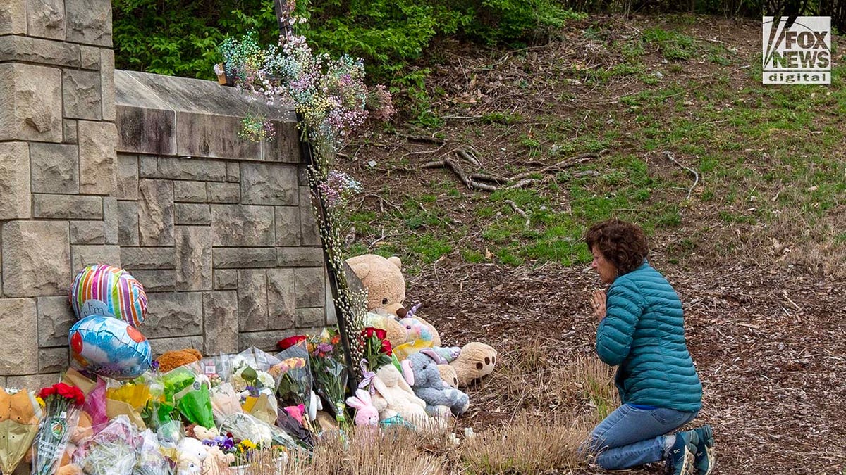 A mourner visits a memorial outside of The Covenant School