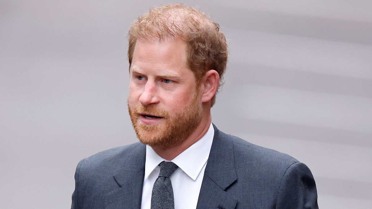Prince Harry in a grey suit and tie outside in London