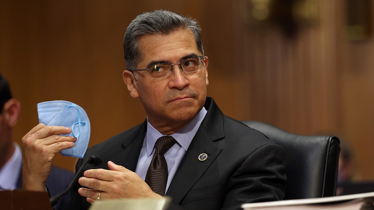 Xavier Becerra holds mask at hearing