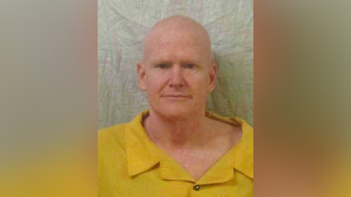 Alex Murdaugh wears a yellow shirt in mugshot and sports shaved head.