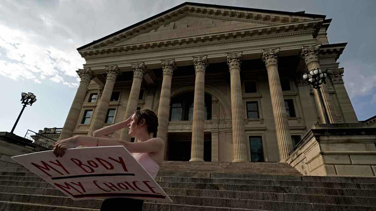 Woman protesting abortion decision