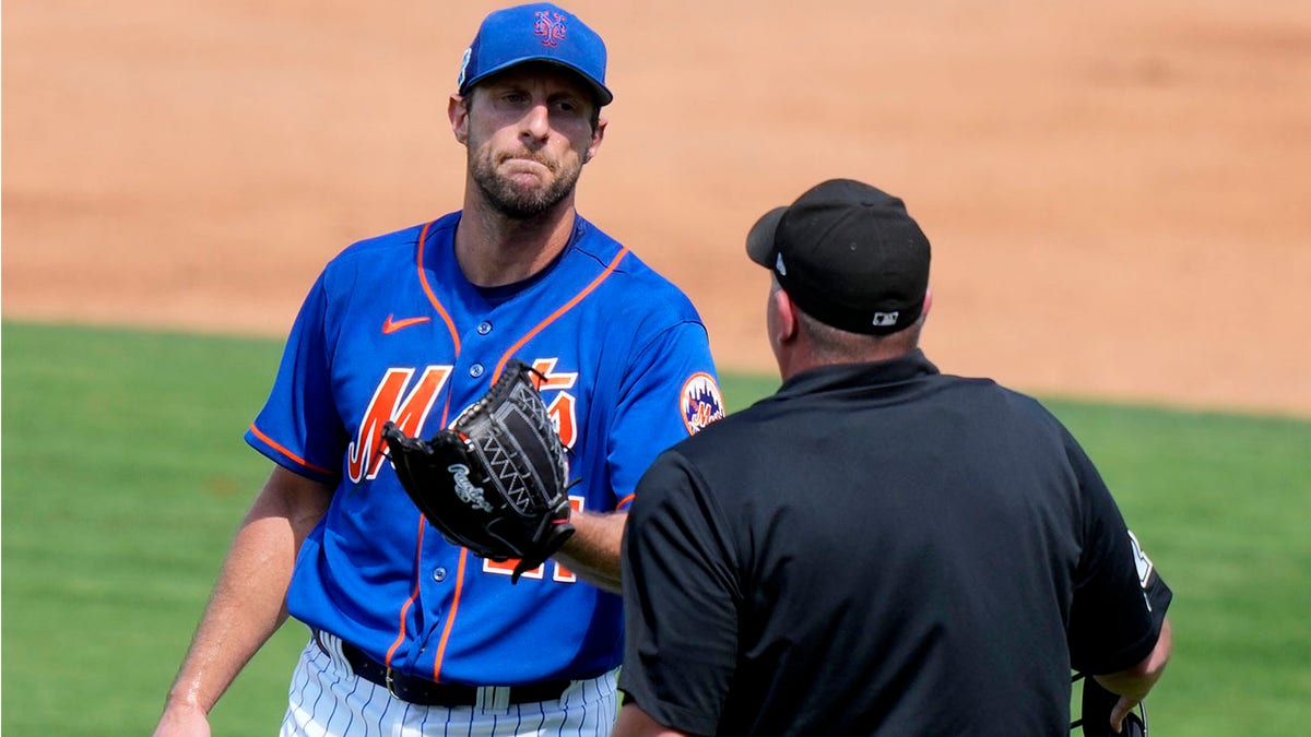 Max Scherzer speaks with an umpire during spring training