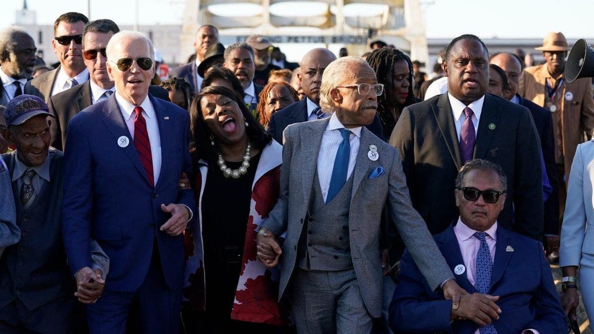 President Joe Biden walks across the Edmund Pettus Bridge