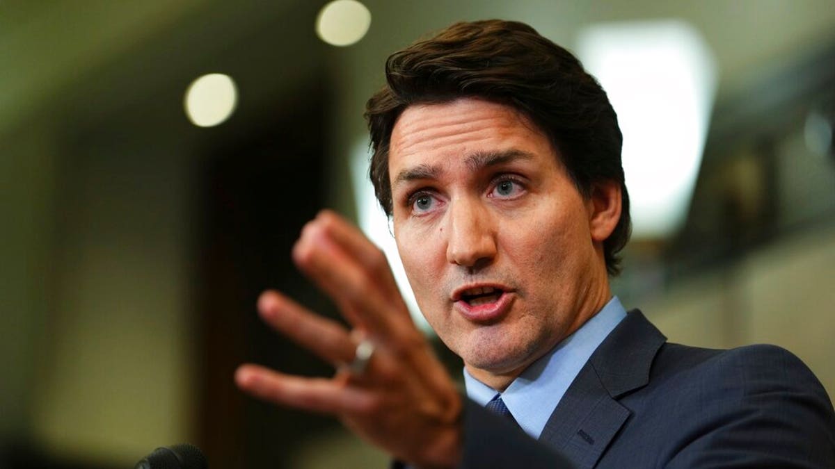 Justin Trudeau gesturing with his left hand in a closeup shot