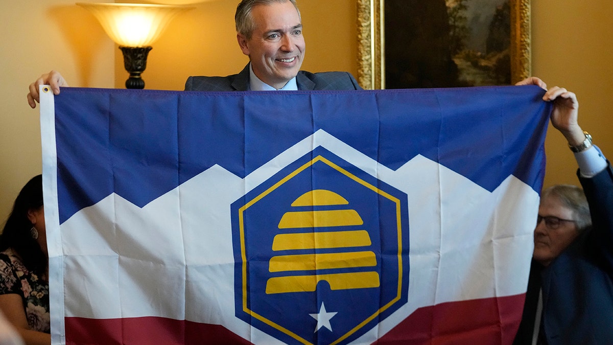 A lawmaker holding Utah's new flag