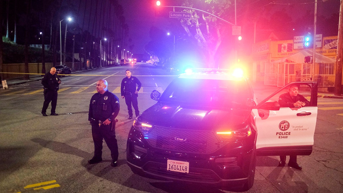 Police officers and an LAPD vehicle