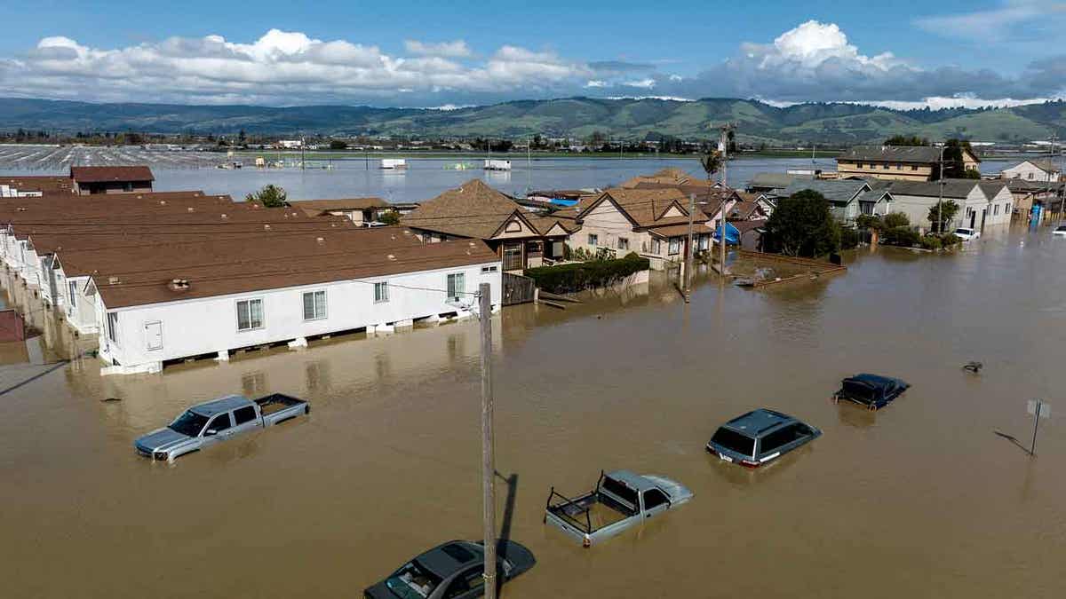 Floodwaters surround homes
