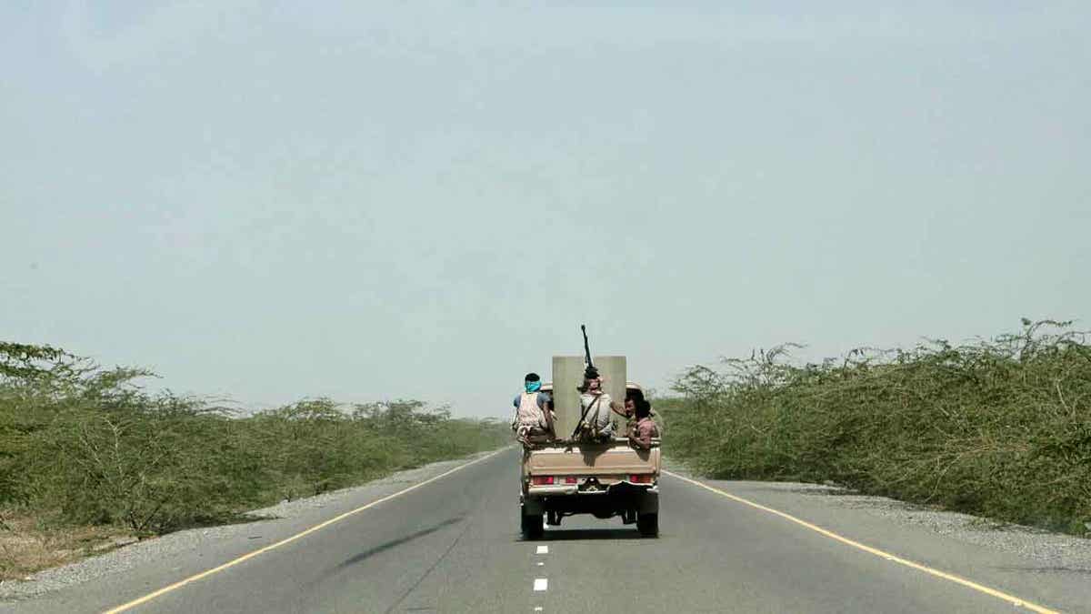 Saudi-backed forces ride in a vehicle