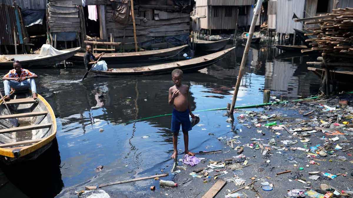 A child stands in filthy water