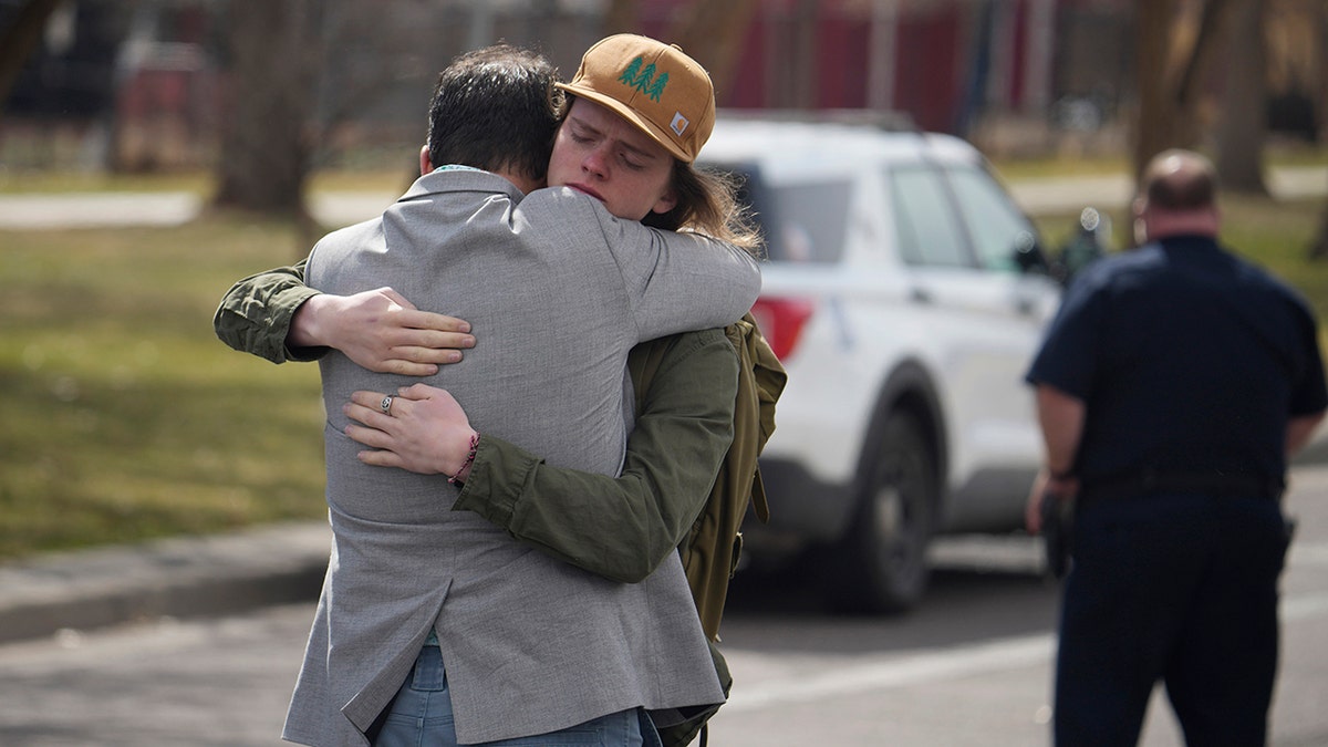 Dad hugs son after Denver high school shooting