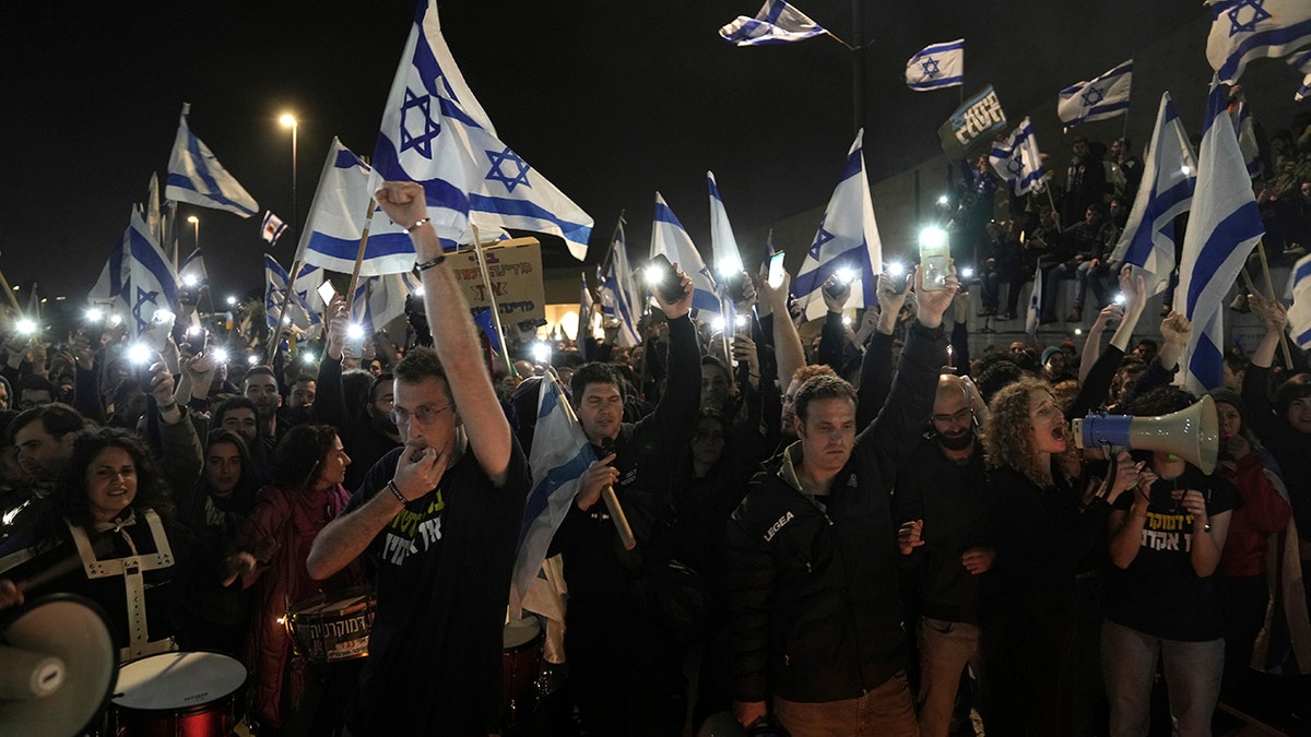 People waving Israeli flags