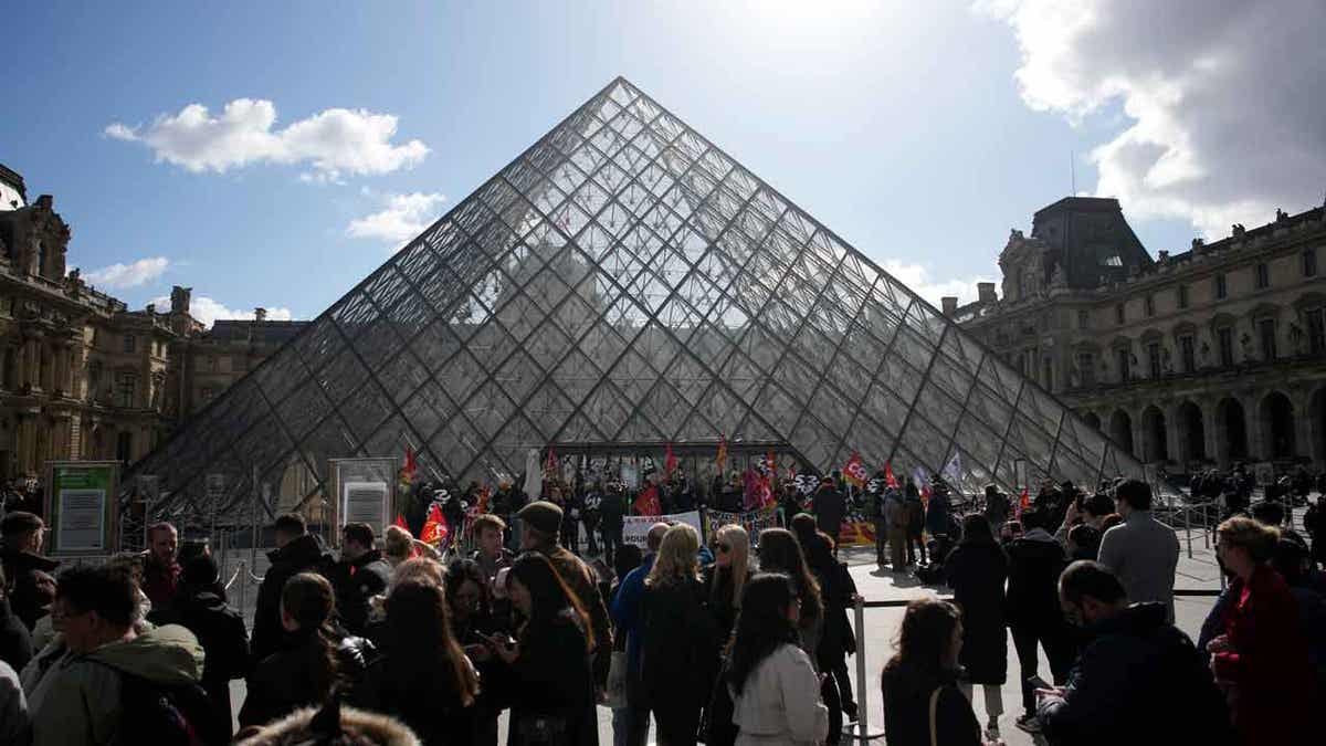 The Louvre with protestors outside