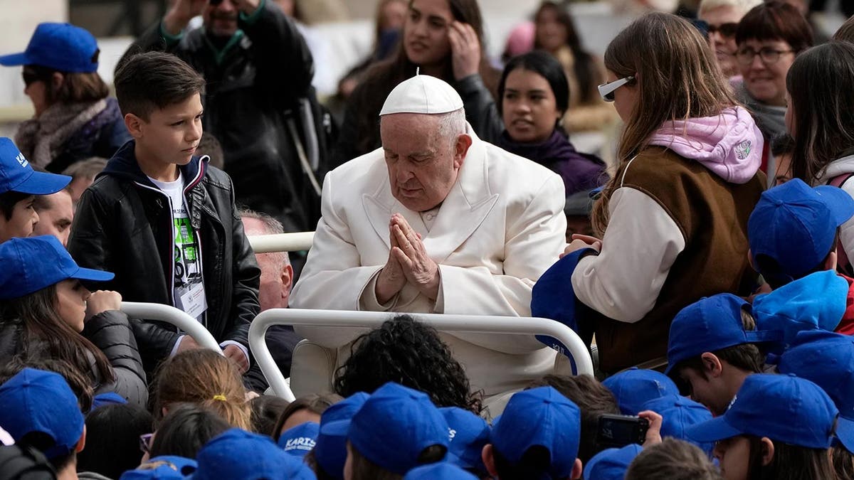 Pope Francis meets children at the end of his weekly general audience in St. Peter's Square, at the Vatican, Wednesday, March 29, 2023. 