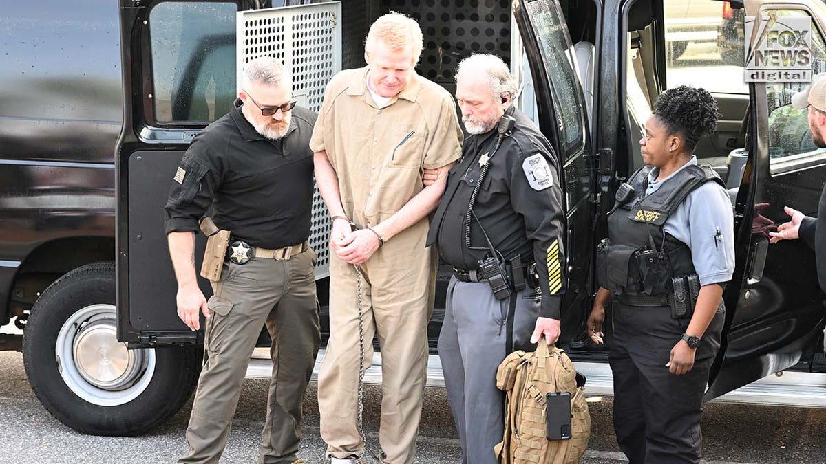 Alex Murdaugh is escorted into the courthouse wearing a tan prison jumpsuit.