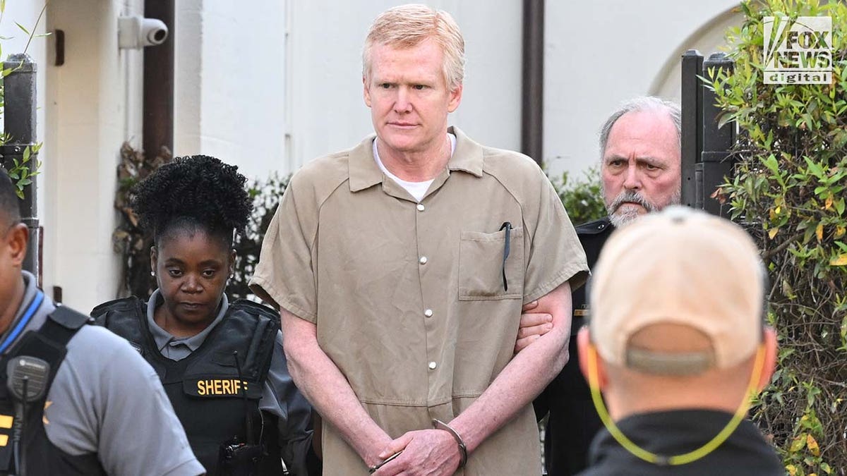 Alex Murdaugh is led out of the Colleton County courthouse in a tan prison jumpsuit.