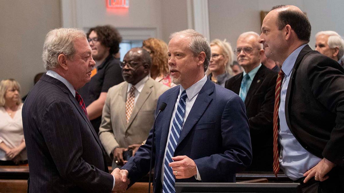 Defense lawyer  Dick Harpootlian and authoritative   Creighton Waters shaking hands astatine  Colleton County Courthouse