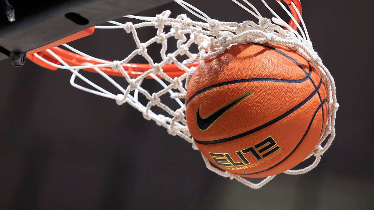 A basketball going through the hoop
