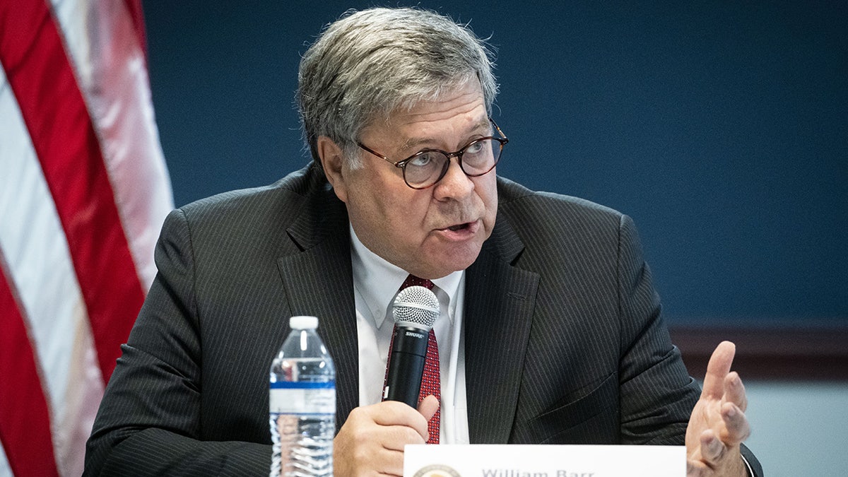 Bill Barr speaks into a mic