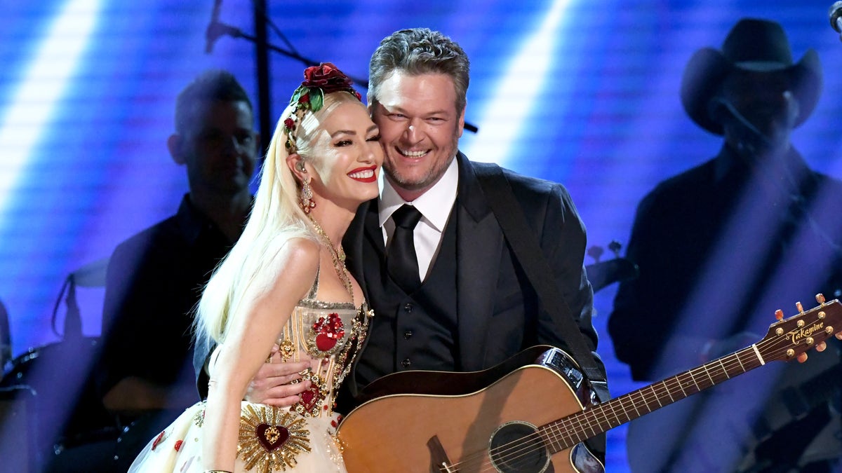 Gwen Stefani rocks white princess dress with gold and red hearts on stage with Blake Shelton at Grammy awards
