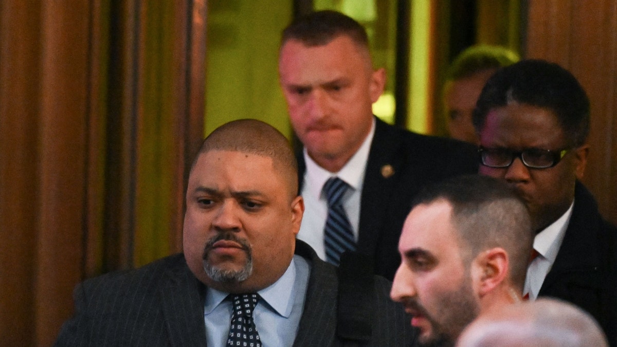 Manhattan District Attorney Alvin Bragg (L) leaves his office