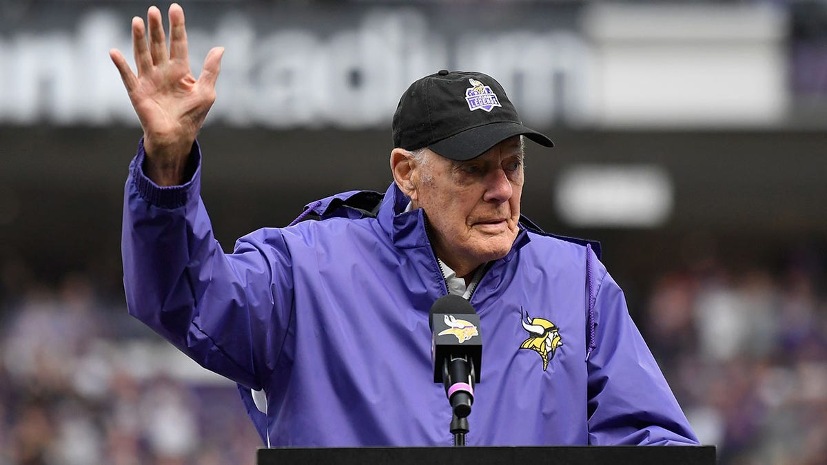Bud Grant waves to the crowd