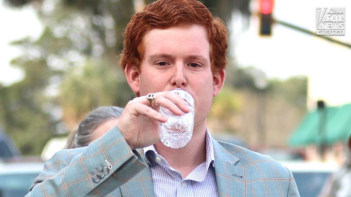 Buster drinking water outside courthouse