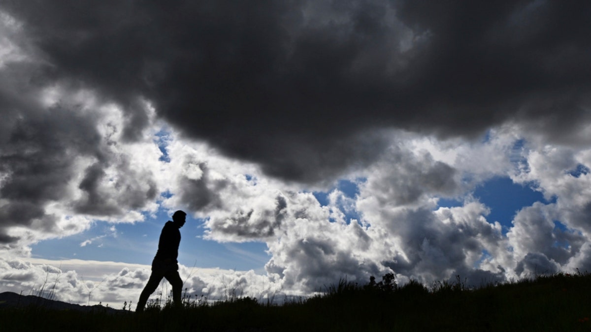 A man walks up a hill in San Rafael, Calif.