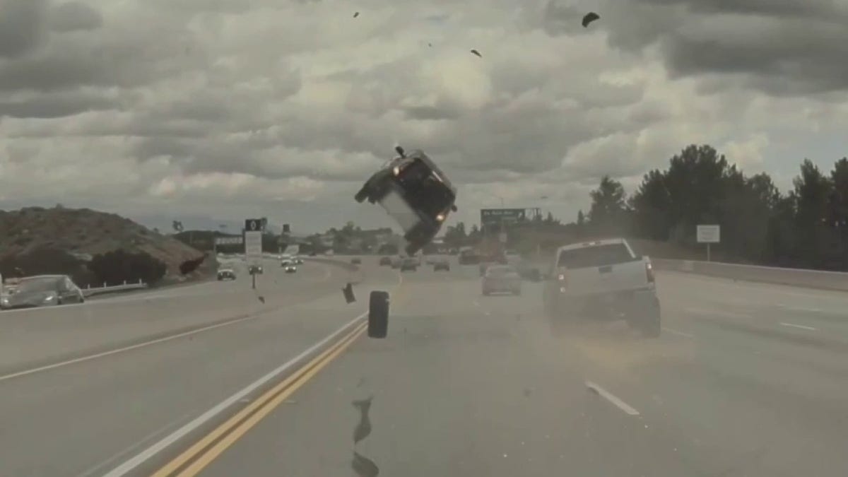 car launched into the air after striking loose tire