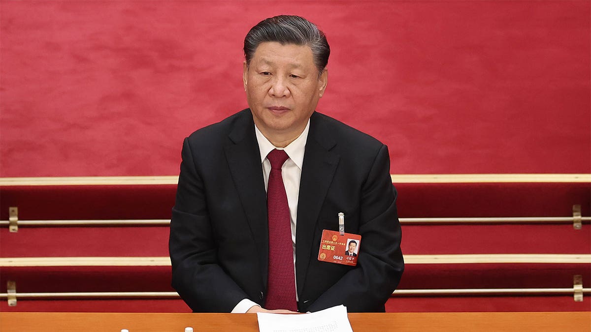 Chinese President Xi Jinping sitting at a session