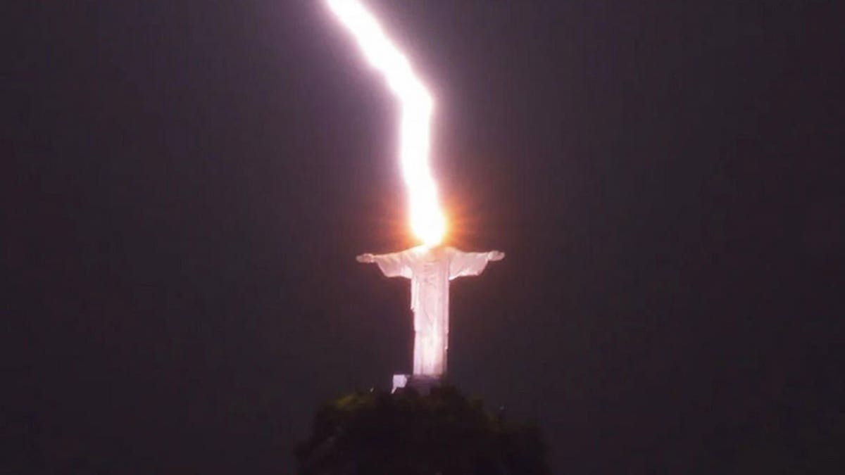 Christ the Redeemer stature being struck by lightning directly overhead.