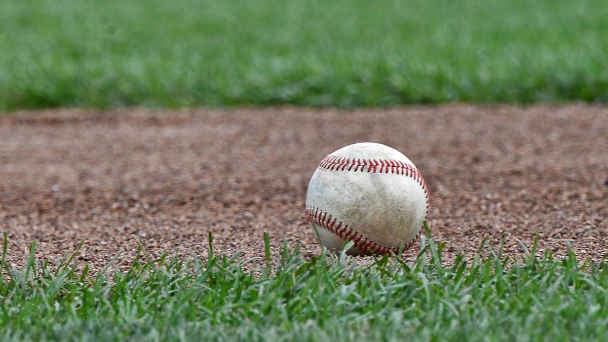 A baseball lays in the field