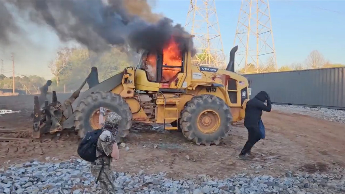 Protesters set construction equipment on fire at the site of a proposed police training facility in Atlanta.