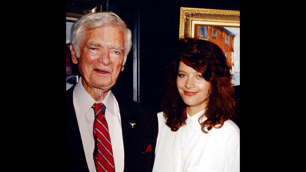 Buddy Ebsen ina dark suit and tie standing next to his daughter Kiki Ebsen in a white blouse