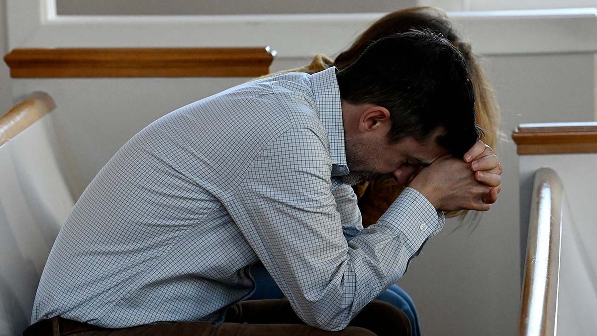 Congregants pray during a vigil at Woodmont Christian Church for victims of the mass shooting at Covenant School