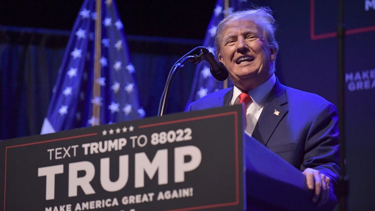 Donald Trump at lectern campaigning in Iowa