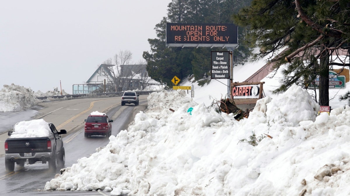 Snow covers the side of a road in Lake Arrowhead, Calif.